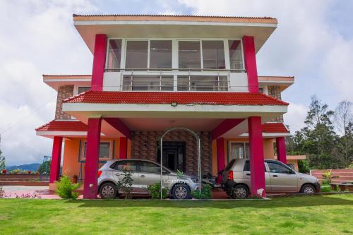 a house with two cars parked in front of it at Green Premium Villa Ooty by Lexstays in Ooty