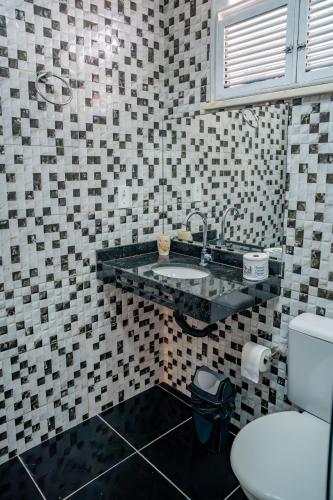 a bathroom with a sink and a toilet at Pousada Coconut Cumbuco in Cumbuco