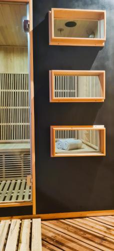 a wall with wooden shelves in a room at Maison d'hôtes et SPA La Boucotte in Vellerot-lès-Vercel