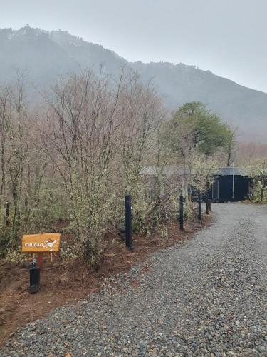a sign on the side of a dirt road at Tiny & Big House Suite Los Mallines de Malalcahuello in Malalcahuello