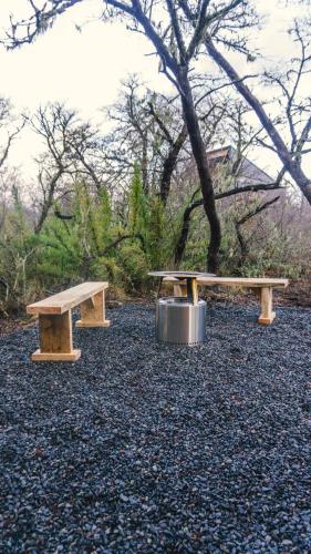 two benches sitting on top of a pile of gravel at Tiny & Big House Suite Los Mallines de Malalcahuello in Malalcahuello