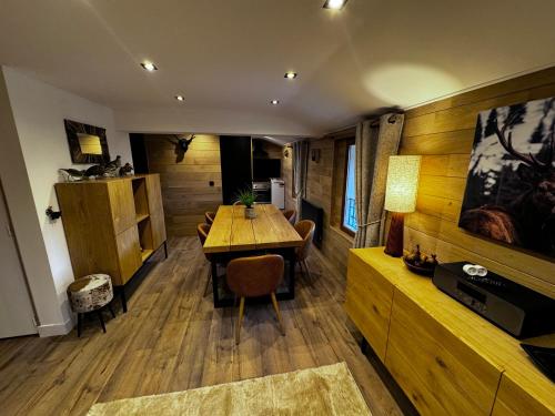 a dining room with a wooden table and chairs at Chalet Millou Beuil in Beuil