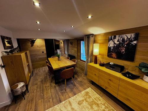a room with a wooden table and a dining room at Chalet Millou Beuil in Beuil