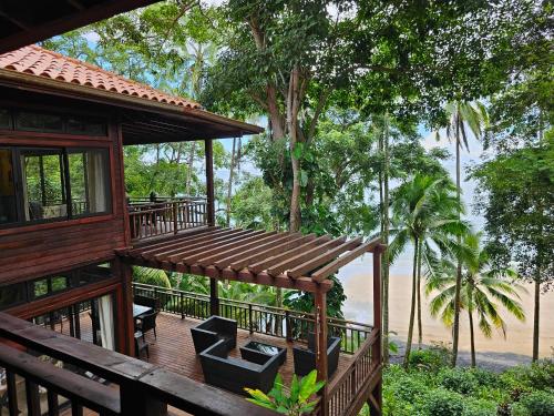 a house with a deck with a view of the water at El Remanso Saboga Suites & Studios in Saboga
