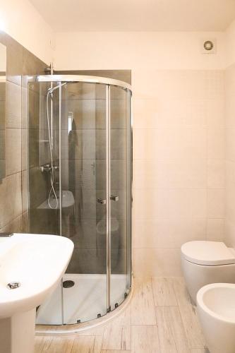 a bathroom with a shower and a toilet and a sink at Udine Center Apartment in Udine