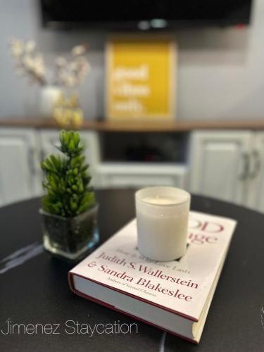 a book with a cup on top of it on a table at Jimenez Staycation Unit 406 Quirino west tower The Residence at Commonwealth by Century in Manila