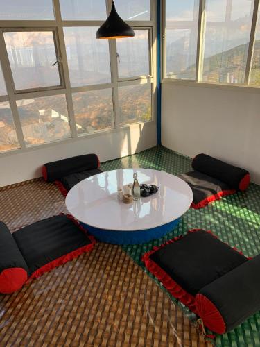 a room with a white table and some windows at sanjivani buti organic krisi farm & resort in Nagarkot