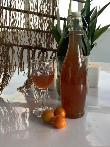 a drink and a glass of juice and some olives on a table at sanjivani buti organic krisi farm & resort in Nagarkot