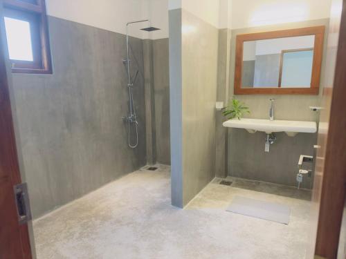 a bathroom with a shower and a sink at New Ocean Breeze Madiha in Matara