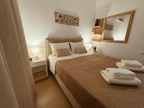 a bedroom with a bed with two towels on it at Archangelos Garden House in Archangelos