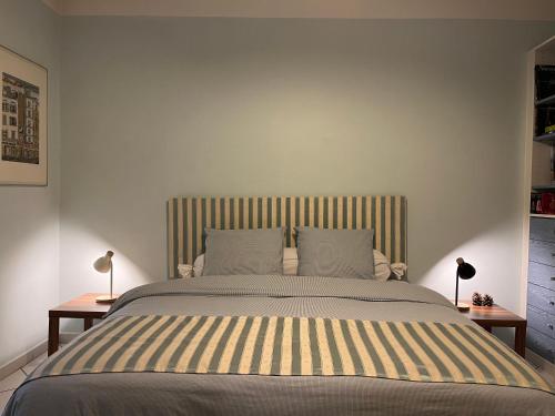 a bedroom with a large bed with two lamps on tables at Chambres d'Hôtes - Le Pin des Arches in Digne-les-Bains