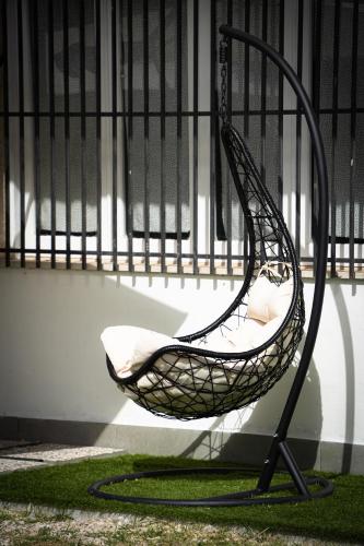 a chair sitting in front of a fence at B&B Aquino in Terrazza in Aquino