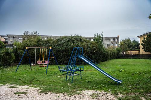 an empty playground with a slide in a yard at B&B Aquino in Terrazza in Aquino