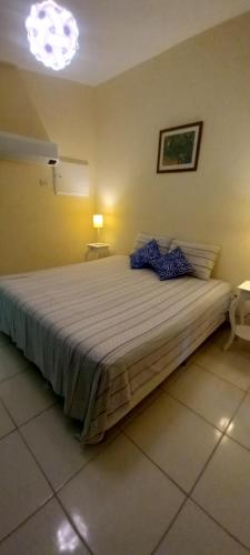 a bedroom with a large bed in a room at Pousada Di Ponta in Goiana