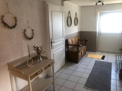 a room with a door and a table and a window at Grande maison à à Bresse avec jacuzzi cheminée et jardin Idéal pour les familles et amis in La Bresse