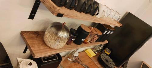 a wooden shelf with utensils on it at KastellRen - Rennes - Grand parking privé in Rennes