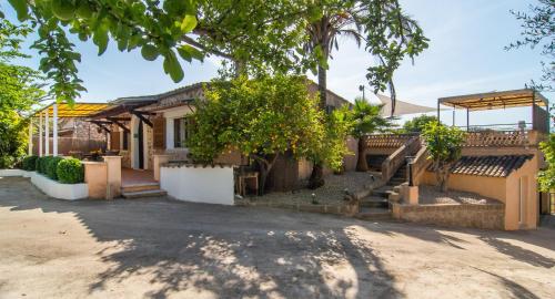 a house with a tree in front of it at Finca Can Tiro in Costitx