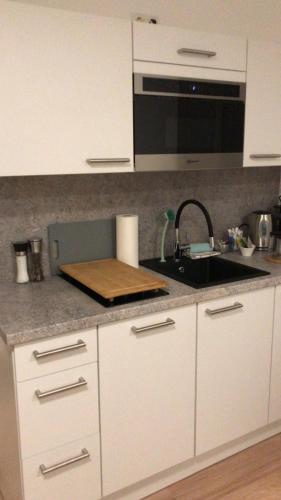 a kitchen with a sink and a counter top at Kleine feine Wohnung Gmunden City in Gmunden