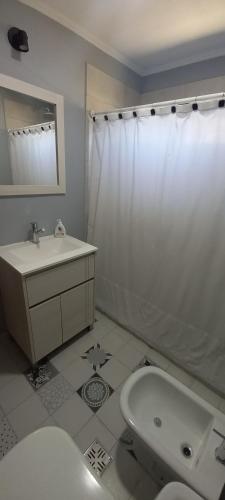 a bathroom with a toilet and a sink and a shower at Casa quinta con pileta - Gardey in Gardey