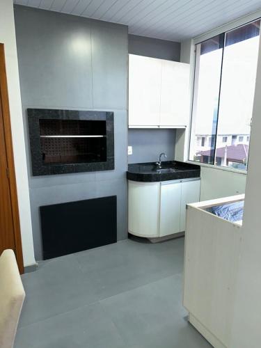Η κουζίνα ή μικρή κουζίνα στο Residencial Wrubleski SC