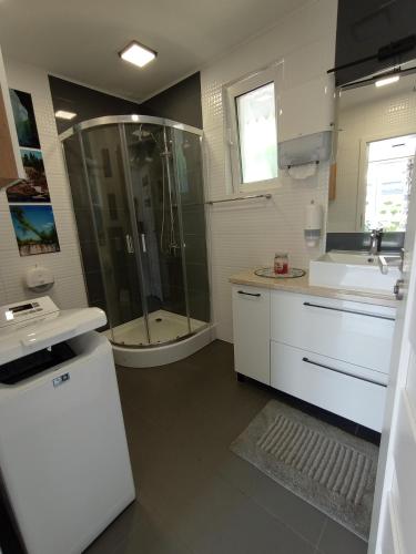a bathroom with a shower and a sink at Zajazd u Marcela in Bysław