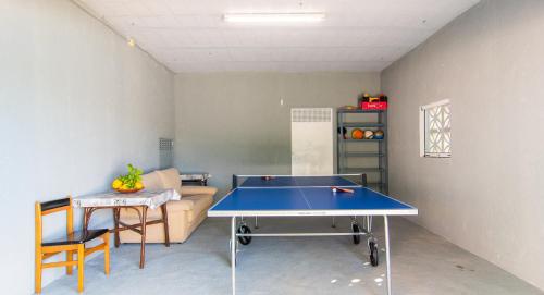 a living room with a ping pong table and a couch at Finca Can Tiro in Costitx