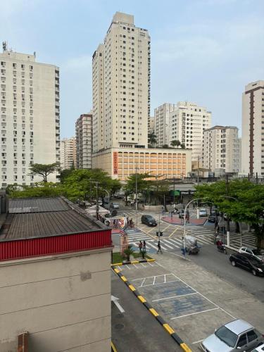 a city with tall buildings and a parking lot at Apartamento Praia Pitangueiras in Guarujá