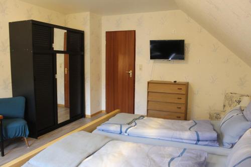a small bedroom with a bed and a dresser at Ferienwohnung Andrea in Grünebach
