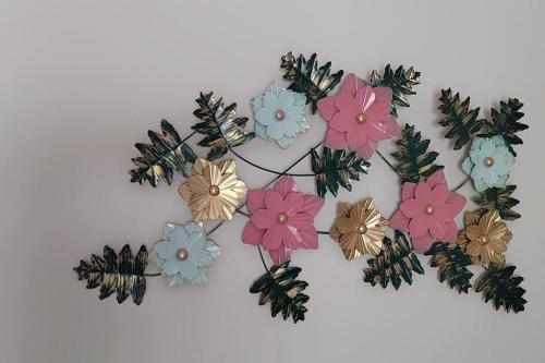 a bunch of flowers hanging on a wall at Gangi Kota East Flat in Kovvūr