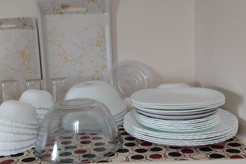 a pile of plates and dishes on a table at Gangi Kota East Flat in Kovvūr