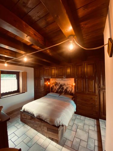 a bedroom with a bed in a room with wooden ceilings at La Casetta di Francio & Marta in Aosta