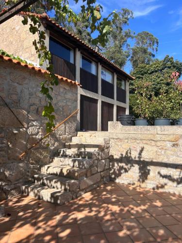 a stone house with a door and stairs at Casa da Eira in Vila do Conde