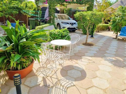 a patio with a white table and chairs and plants at Magnifique villa avec piscine a Mbour in Mbour