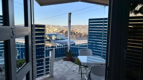 a balcony with a view of a car on a road at Celestia Boutique Inn - Boutique Stay Overlooking Jerash Ruins in Jerash
