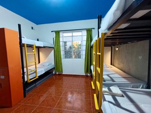 a dorm room with bunk beds and a window at Ding-Dong Hostel in Cali