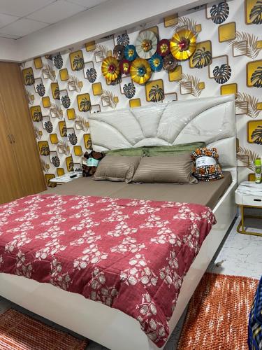 a bedroom with a bed and a wall with pictures at Couple Love Condos 1BHK in Zirakpur