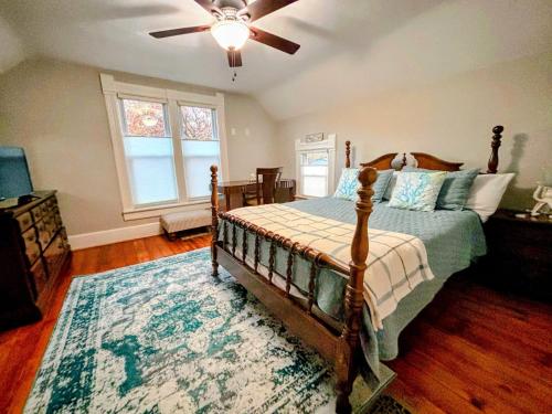 a bedroom with a bed and a ceiling fan at Charming Restored 1891 House in Fort Atkinson