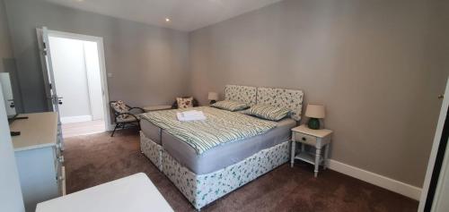 a small bedroom with a bed and a window at Place to Stay in Thames Ditton in London