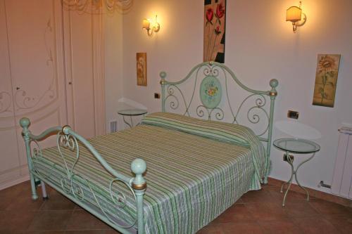 a bedroom with a bed with two glass tables at Casa Dolce Acqua in Capannori