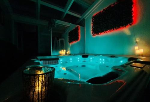 a jacuzzi tub with lights in a room at Charmante et accueillante maison in Saint-Pierre-dʼOléron