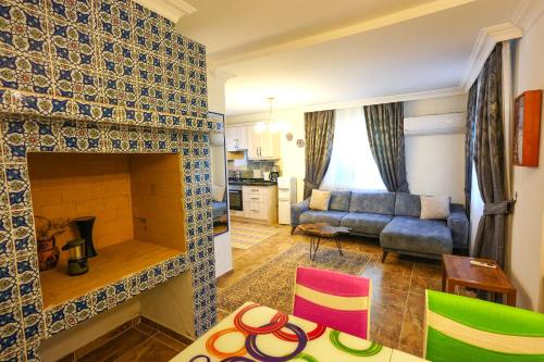 a living room with a fireplace and a couch at Villa Misli - Heart of Dalyan and Newly Renovated in Dalyan