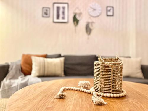 a rattan basket sitting on a table in a living room at Modern Boho Charm in Kallio, Walk to City Center in Helsinki