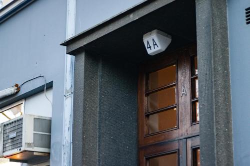 a sign above a door with the number on it at Modern Boho Charm in Kallio, Walk to City Center in Helsinki