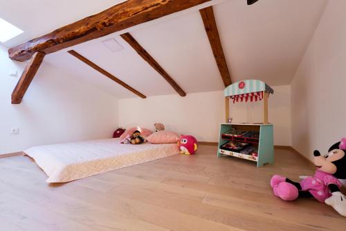 a bedroom with a bed with stuffed animals in it at Vila Tia in Karlovac