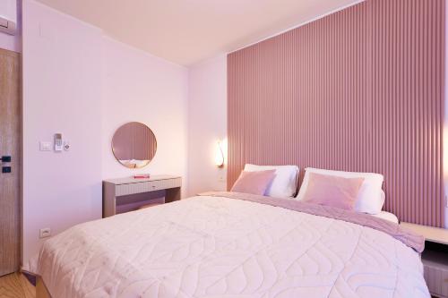 a bedroom with a large bed and a mirror at Vila Tia in Karlovac