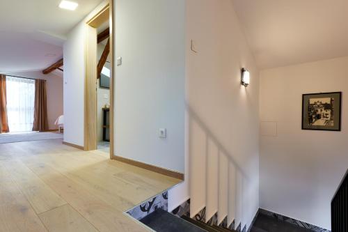 a hallway of a house with white walls and wooden floors at Vila Tia in Karlovac