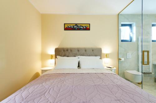 a bedroom with a large bed with a purple comforter at Vila Tia in Karlovac