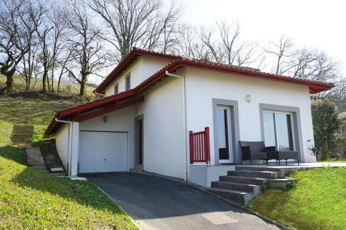 une petite maison blanche avec un toit rouge dans l'établissement Trés belle villa 4 étoiles - 3 chambres - Terrasse et jardin, à Cambo-les-Bains