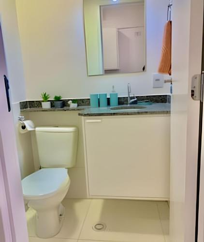 a small bathroom with a toilet and a sink at Studio Vertentes in Sao Paulo