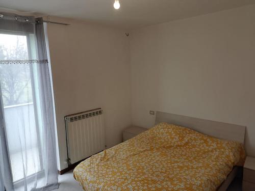 a bedroom with a bed and a window at bilocale con giardino in Zibido al Lambro